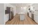 Spacious kitchen featuring stainless steel appliances, a central island, and white cabinetry at 1318 E Mission Grande Ave, Casa Grande, AZ 85122