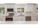 Well-lit kitchen with stainless steel appliances, white countertops, and ample cabinet space at 1318 E Mission Grande Ave, Casa Grande, AZ 85122
