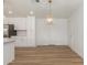 Open-concept dining area featuring stainless steel appliances and white cabinets at 1318 E Mission Grande Ave, Casa Grande, AZ 85122