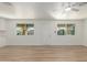 Bright living room with neutral walls, wood-look floors, a ceiling fan, and ample natural light at 1318 E Mission Grande Ave, Casa Grande, AZ 85122