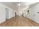 Bright, open-concept living room with luxury vinyl plank flooring and a modern ceiling fan at 1318 E Mission Grande Ave, Casa Grande, AZ 85122