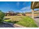 Spacious backyard featuring a gazebo, lush lawn, block wall and string lights perfect for entertaining at 13307 W Paso Trl, Peoria, AZ 85383