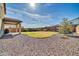 Expansive backyard with stone landscaping and a covered patio, perfect for outdoor living at 13307 W Paso Trl, Peoria, AZ 85383