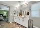 Bright bathroom featuring a double sink vanity with stylish fixtures and a modern, neutral color scheme at 13307 W Paso Trl, Peoria, AZ 85383