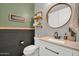 Charming bathroom with a modern sink, round mirror, and decorative rustic accents at 13307 W Paso Trl, Peoria, AZ 85383