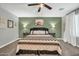 Cozy bedroom featuring a decorative wall, ceiling fan, and stylish furnishings at 13307 W Paso Trl, Peoria, AZ 85383
