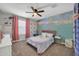 Bright bedroom with a sequin accent wall, soft pink curtains, and a comfortable bed setting at 13307 W Paso Trl, Peoria, AZ 85383
