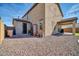 Back exterior of home with low maintenance rock landscaping and covered patio at 13307 W Paso Trl, Peoria, AZ 85383