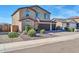 A landscaped two-story home showing the front yard and a three-car garage on a sunny day at 13307 W Paso Trl, Peoria, AZ 85383
