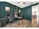 Stylish home office features custom built-ins, ample workspace, and a view into the kitchen at 13307 W Paso Trl, Peoria, AZ 85383