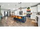 Open-concept kitchen with a large island, stainless steel appliances, and seamless flow to the dining area at 13307 W Paso Trl, Peoria, AZ 85383