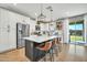 Bright, open kitchen with white cabinets, stainless steel appliances, and a large center island with seating at 13307 W Paso Trl, Peoria, AZ 85383