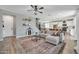 Spacious living room with a large sofa, modern decor, and an open-concept design at 13307 W Paso Trl, Peoria, AZ 85383