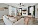 Comfortable living room featuring a fireplace, ceiling fan, and stylish furnishings at 13307 W Paso Trl, Peoria, AZ 85383