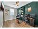 Stylish home office featuring built-in shelving, modern desks, and wood-look flooring at 13307 W Paso Trl, Peoria, AZ 85383