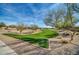 Well maintained community park with walking paths, green spaces, mature trees, and desert landscaping at 13307 W Paso Trl, Peoria, AZ 85383
