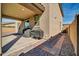 View of the covered patio with dual grills and a brick walkway lined with desert landscaping at 13307 W Paso Trl, Peoria, AZ 85383