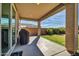 Covered patio with a grill, concrete flooring, and views of the grassy backyard and privacy wall at 13307 W Paso Trl, Peoria, AZ 85383