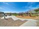View of the community playground featuring a slide, picnic bench, and manicured green spaces at 13307 W Paso Trl, Peoria, AZ 85383