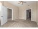 Bedroom features carpet, neutral paint, and access to other areas of the home at 14575 W Mountain View Blvd # 11221, Surprise, AZ 85374