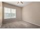 Carpeted bedroom boasts natural light, and neutral paint at 14575 W Mountain View Blvd # 11221, Surprise, AZ 85374