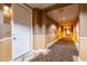 Hallway with a carpeted floor leads to the unit, adjacent to the unit number on the wall at 14575 W Mountain View Blvd # 11221, Surprise, AZ 85374