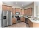 Well-equipped kitchen features stainless steel appliances, granite countertops, and ample wood cabinetry at 14575 W Mountain View Blvd # 11221, Surprise, AZ 85374