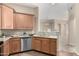 Bright kitchen features stainless appliances, granite counters, wood cabinets and is open to the common areas at 14575 W Mountain View Blvd # 11221, Surprise, AZ 85374