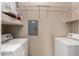 The laundry room has a front-loading washer and dryer and overhead shelving for storage at 14575 W Mountain View Blvd # 11221, Surprise, AZ 85374