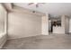 Open living room featuring a large window, neutral walls and carpet, and an open access to the kitchen at 14575 W Mountain View Blvd # 11221, Surprise, AZ 85374