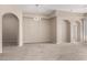 Open living space with arched doorways and views to the outdoor provide great flow and natural light at 14575 W Mountain View Blvd # 11221, Surprise, AZ 85374