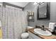 Well-lit bathroom with shower/tub combo, a framed mirror, and neutral decor at 1531 S Owl Dr, Gilbert, AZ 85296