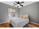 Cozy bedroom with natural light, wood floors, and a comfortable bed with stylish pillows at 1531 S Owl Dr, Gilbert, AZ 85296
