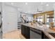 Open-concept kitchen showcases sleek black cabinetry and granite countertops, flowing into the living area at 1531 S Owl Dr, Gilbert, AZ 85296