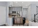 Stylish kitchen with stainless steel refrigerator, grey cabinets and a breakfast bar with stool seating at 1531 S Owl Dr, Gilbert, AZ 85296