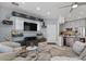 Open-concept living room features sleek shelving, modern furniture, and an adjacent kitchen with stainless steel appliances at 1531 S Owl Dr, Gilbert, AZ 85296