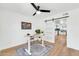 Home office with a modern desk, ceiling fan, and sliding door with view to kitchen at 15609 N 59Th St, Scottsdale, AZ 85254