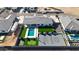 An aerial view of a home with a backyard oasis, featuring a pool, putting green, and sports court at 16832 E Hazeltine Way, Queen Creek, AZ 85142