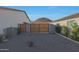 The backyard features an electric gate, privacy wall, and desert landscaping at 16832 E Hazeltine Way, Queen Creek, AZ 85142