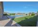 A pristine pool is surrounded by lush turf and meticulous landscaping at 16832 E Hazeltine Way, Queen Creek, AZ 85142