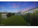 Expansive backyard featuring lush artificial turf, swimming pool, basketball court and RV parking at 16832 E Hazeltine Way, Queen Creek, AZ 85142