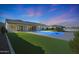 Backyard featuring a sparkling pool, lush artificial grass, and well-maintained landscaping, perfect for relaxation at 16832 E Hazeltine Way, Queen Creek, AZ 85142