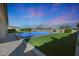 Backyard featuring a sparkling pool, lush artificial grass, and well-maintained landscaping, perfect for relaxation at 16832 E Hazeltine Way, Queen Creek, AZ 85142