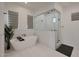 Elegant bathroom featuring a modern soaking tub, a glass shower, and a neutral color scheme at 16832 E Hazeltine Way, Queen Creek, AZ 85142