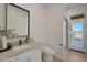 Modern bathroom featuring a vanity with stone countertops, a toilet, and a glass shower, with a pool view at 16832 E Hazeltine Way, Queen Creek, AZ 85142
