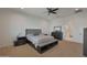 Primary bedroom featuring neutral tones, ceiling fan, and a door leading to the bathroom at 16832 E Hazeltine Way, Queen Creek, AZ 85142