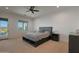 Well-lit bedroom featuring a king-sized bed, bedside tables, and a door that leads to the backyard at 16832 E Hazeltine Way, Queen Creek, AZ 85142