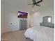 Large bedroom featuring a TV, ceiling fan, two dressers, and two doors at 16832 E Hazeltine Way, Queen Creek, AZ 85142