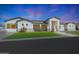 An exterior elevation of a modern single Gathering home with a well-manicured lawn and charming facade at 16832 E Hazeltine Way, Queen Creek, AZ 85142