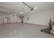 Spacious garage featuring epoxy flooring, ample storage space, and golf bag at 16832 E Hazeltine Way, Queen Creek, AZ 85142